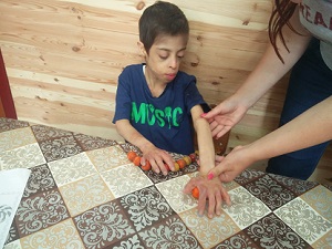 Kyle rolling the plasticine.