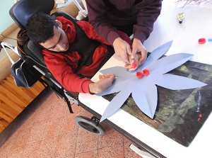 Recycling caps to make a flower - Shylon during horticulture lesson.